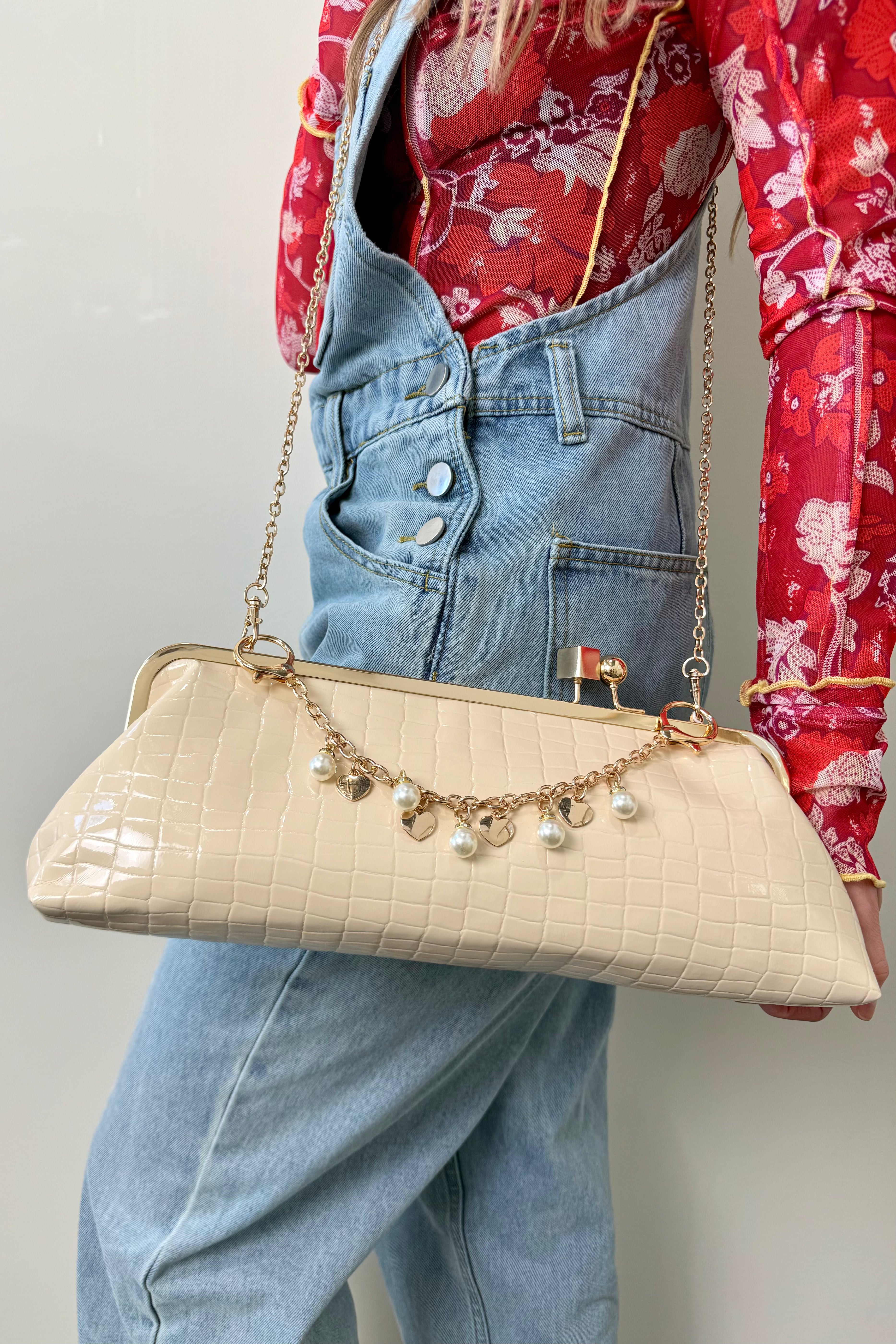 bag charm with gold hardware, pearls, and gold hearts