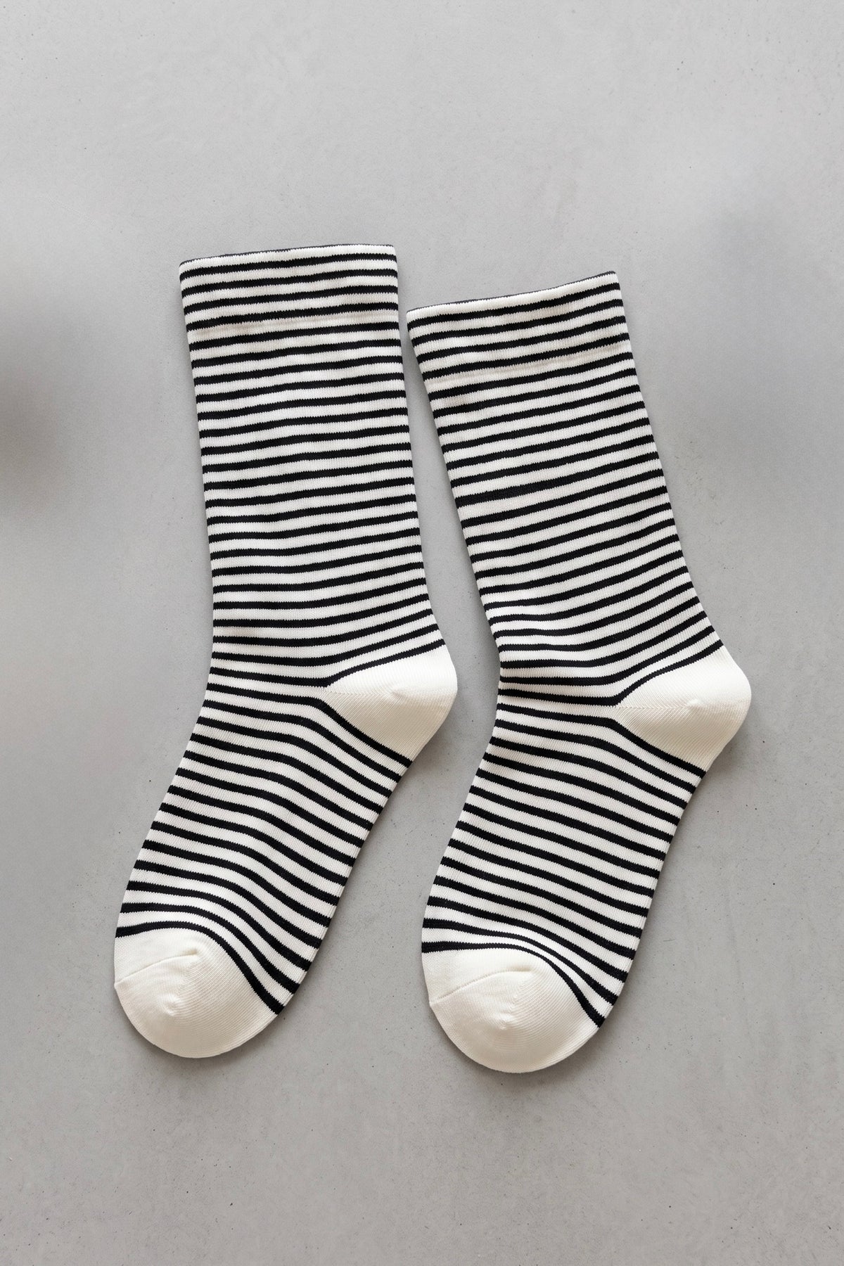 Women's light blue and white striped cotton crew socks with solid white heel and toe detailing.