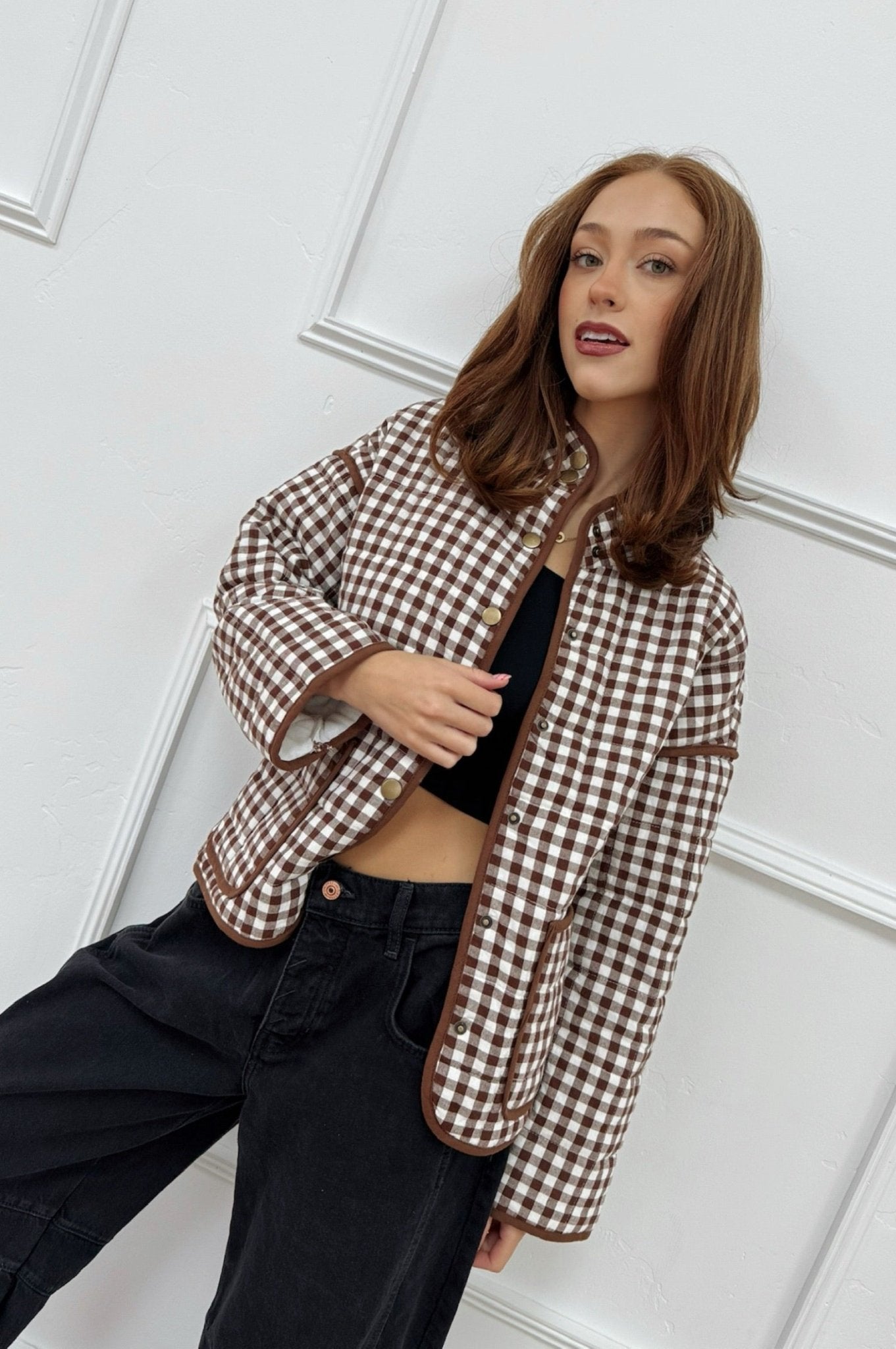 girl in brown gingham jacket with snap buttons and front functional
pockets