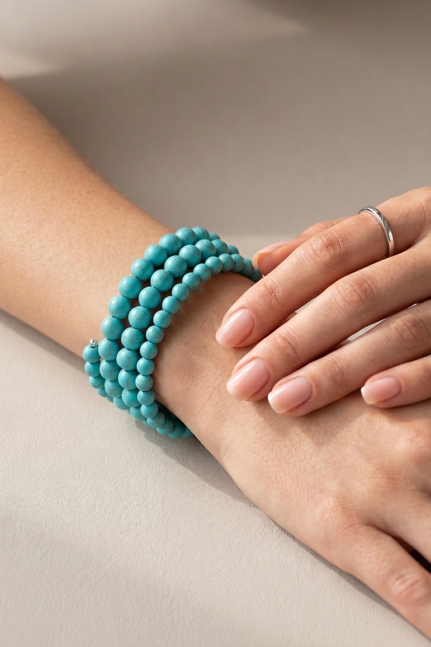 Handmade memory wire wrap bracelet featuring multiple rows of round synthetic turquoise beads in graduated 6mm and 8mm sizes.