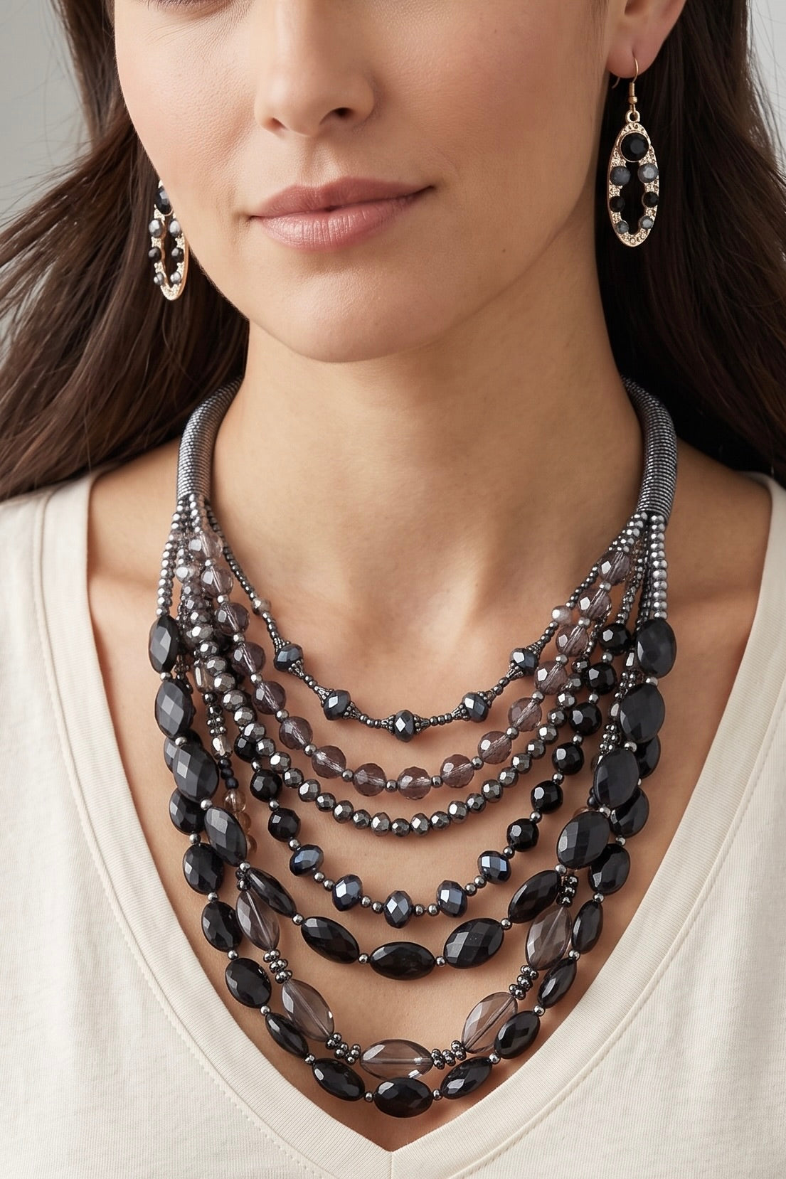 Black multi-layer crystal bead statement necklace with coordinating crystal drop earrings featuring cascading strands of faceted beads and an adjustable collar design.