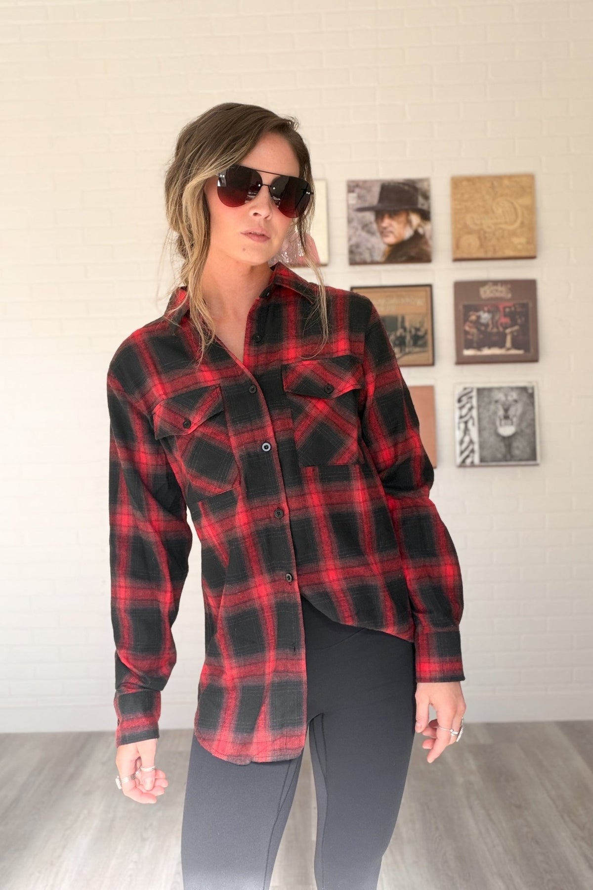 Women’s red, black and cream plaid flannel button-down shirt featuring a relaxed oversized fit, collared neckline, long sleeves, button front closure and dual chest flap pockets. Classic tartan plaid shirt styled as an easy layering piece for casual, grunge-inspired and fall outfits.
