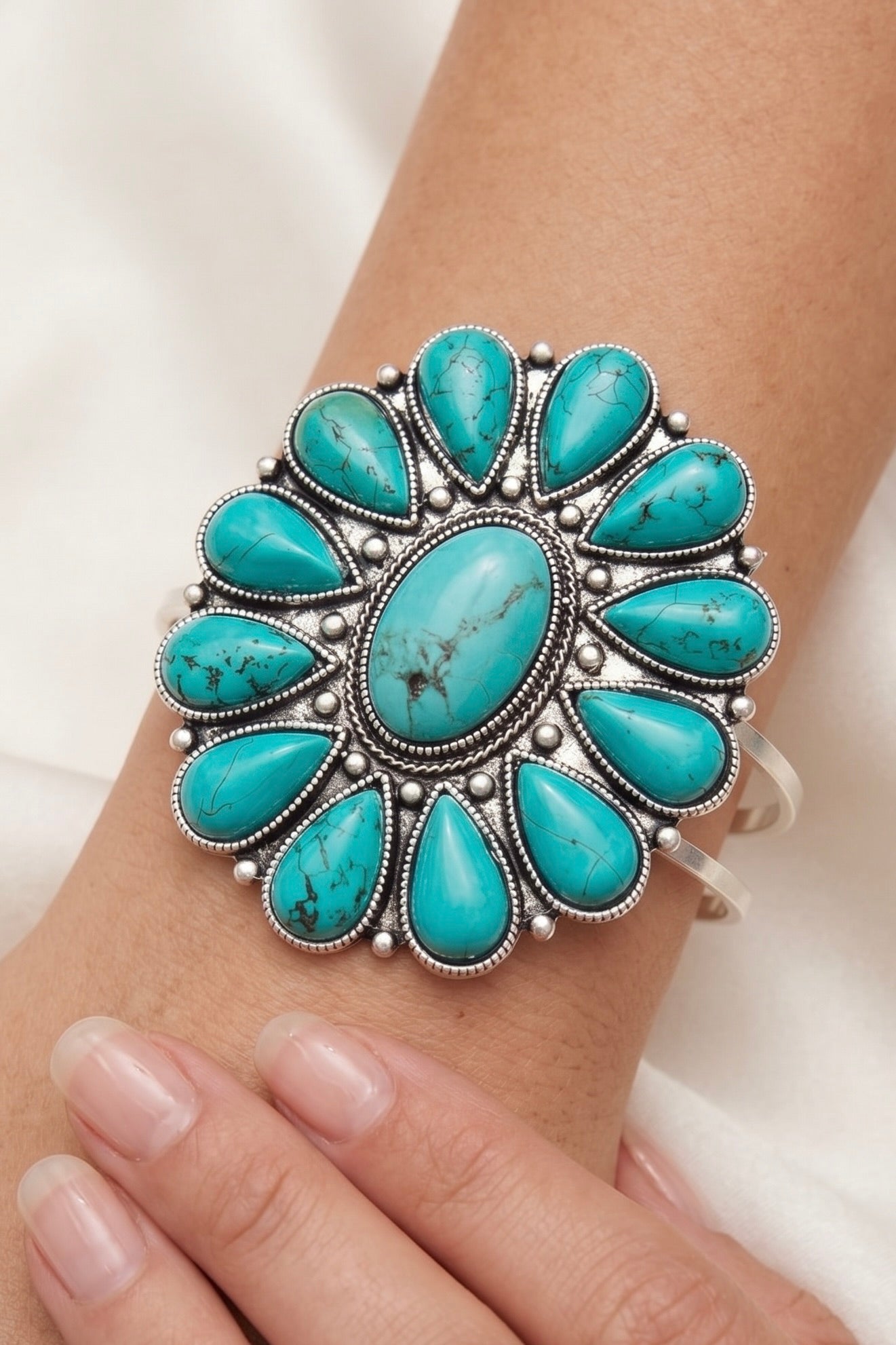 Navajo-style turquoise cluster cuff bracelet with oversized natural turquoise stones and an antique silver split shank cuff.