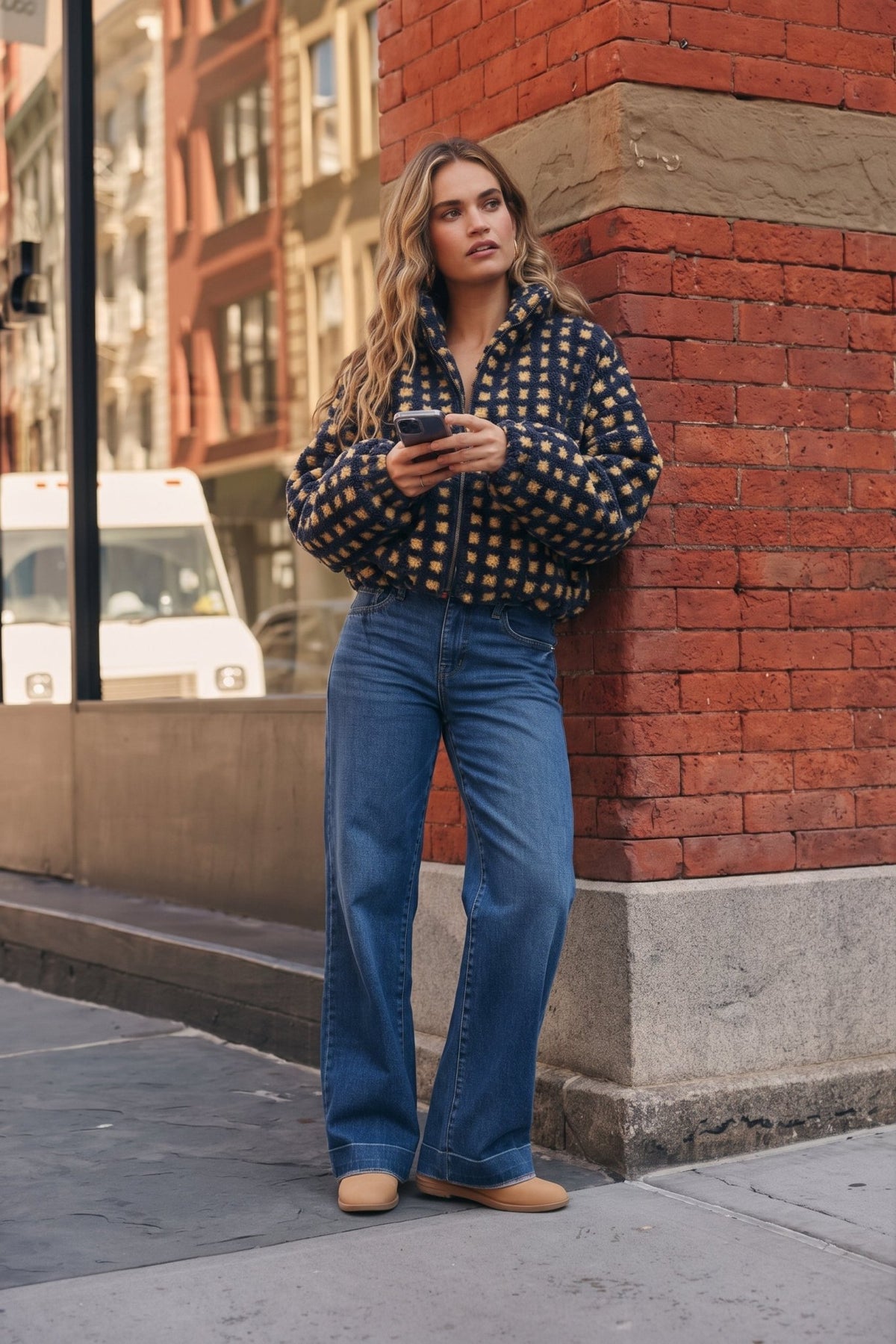 Women's navy blue and buttery yellow checkered sherpa fleece zip-up jacket featuring an allover gingham-inspired square pattern, plush textured teddy fabric, oversized relaxed silhouette, high stand collar, full front zipper closure, long voluminous sleeves with gathered elastic cuffs, and an adjustable drawstring hem for a customizable fit. This cozy, cropped-style sherpa jacket combines retro checkerboard styling with a playful, sporty aesthetic, perfect for casual fall outfits, winter layering, everyday