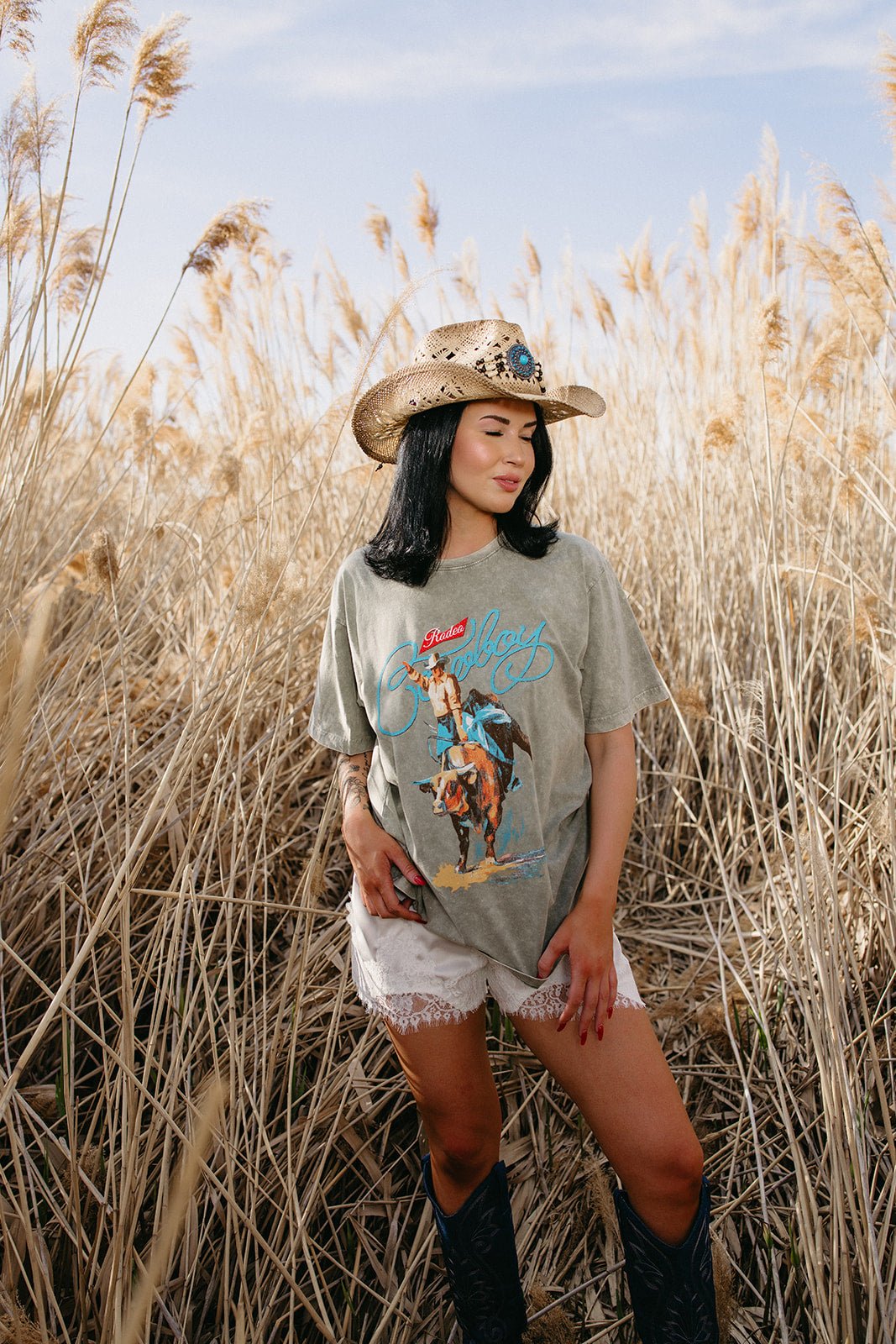 Western graphic tee, vintage rodeo shirt, oversized cowboy t-shirt, faded graphic tee, country concert outfit, boho western style, women's western fashion.