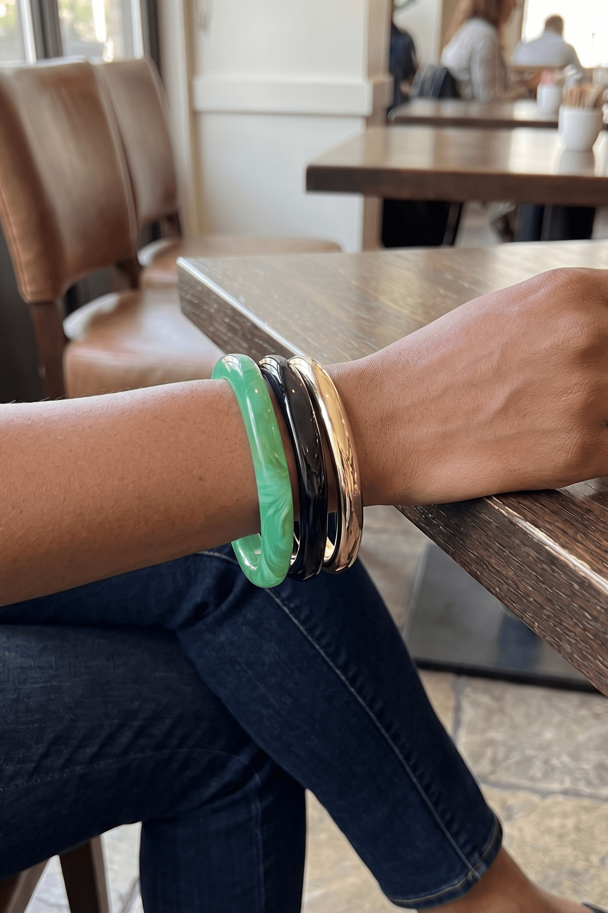 fun bracelet stack with a green, gold, and black bangle