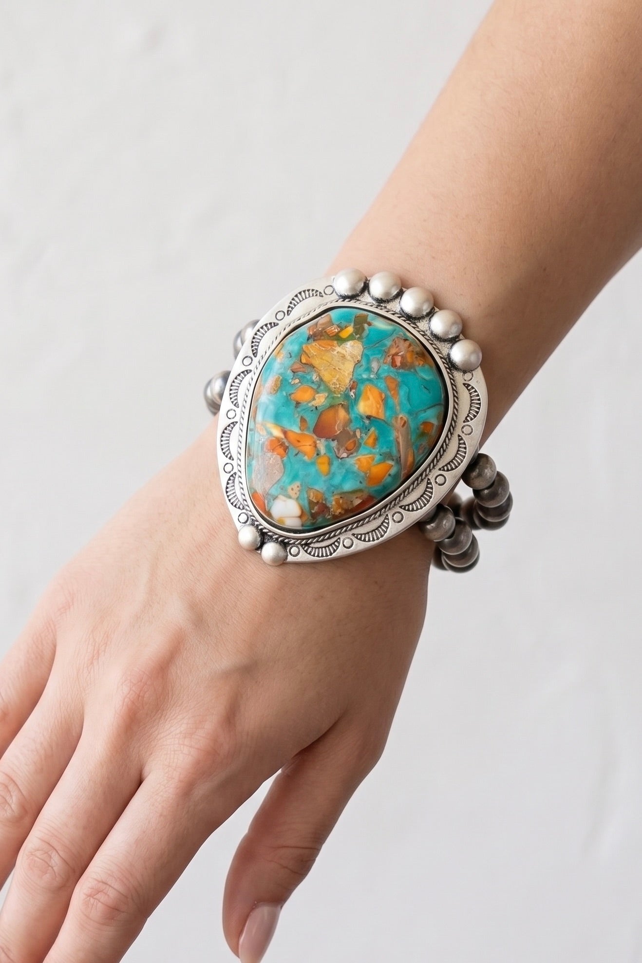 Double-strand western bead stretch bracelet featuring an oversized turquoise and copper gemstone centerpiece with an antique silver setting.