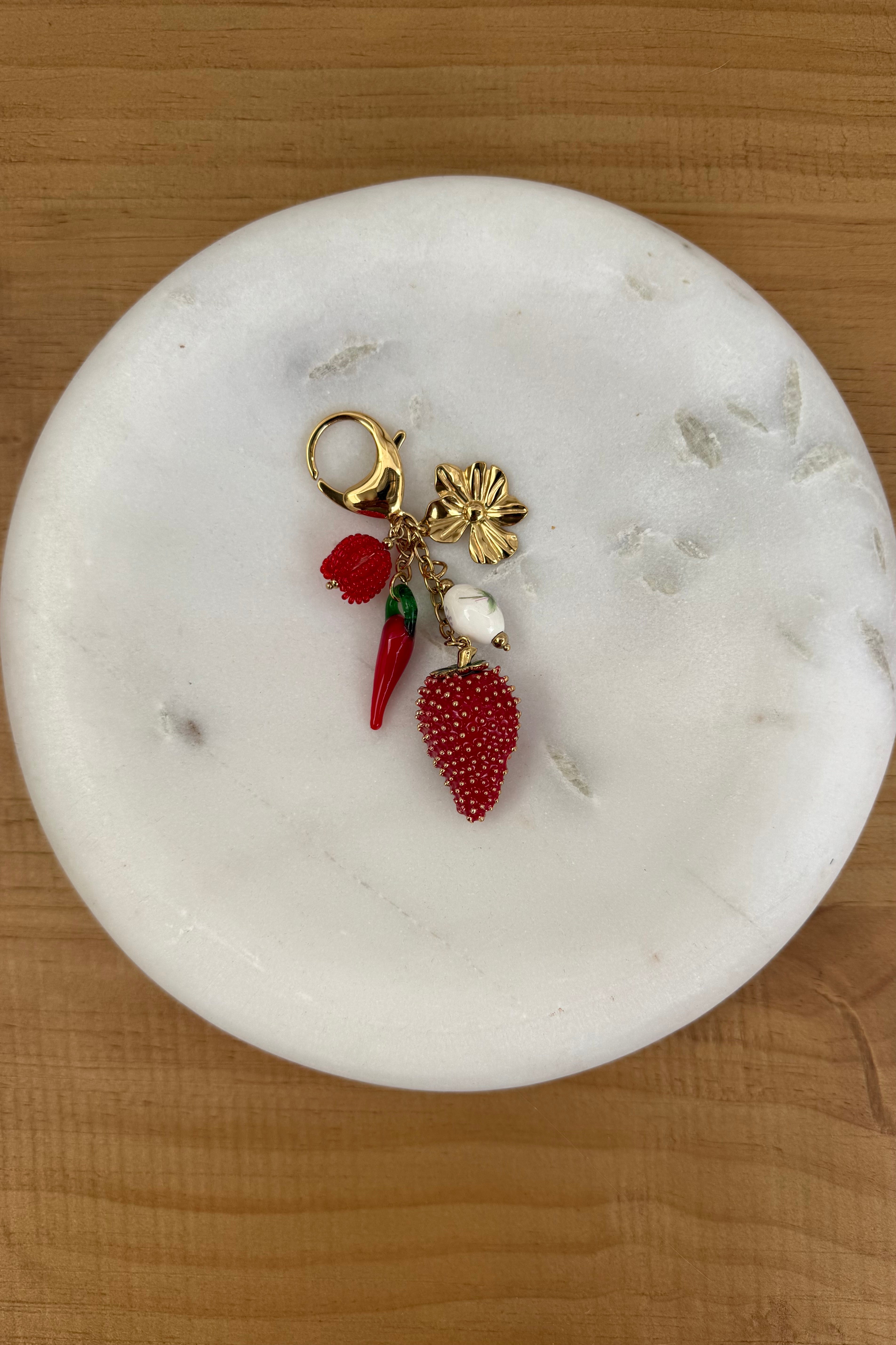 keychain with strawberry and other red objects