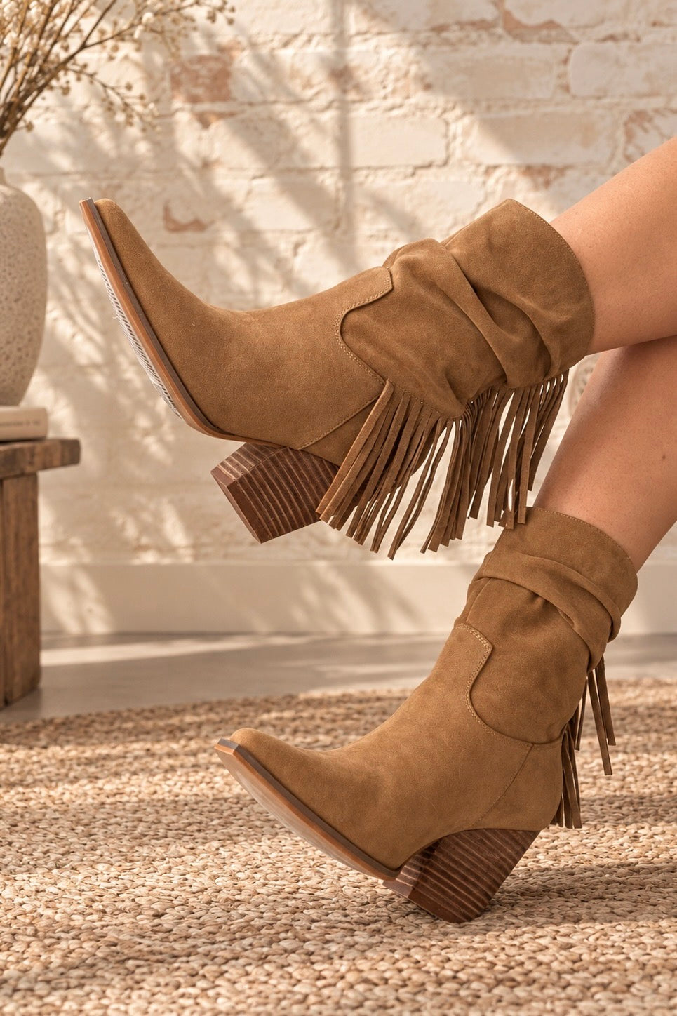Brown slouch Western ankle boot with cascading fringe, pointed toe and 3.5-inch stacked block heel.