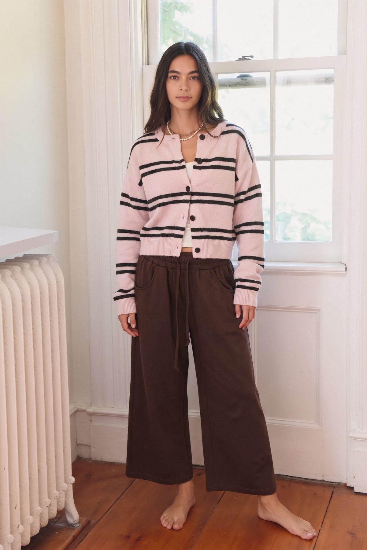 Striped button up knit cardigan in pink and brown stripe and brown and white stripe.