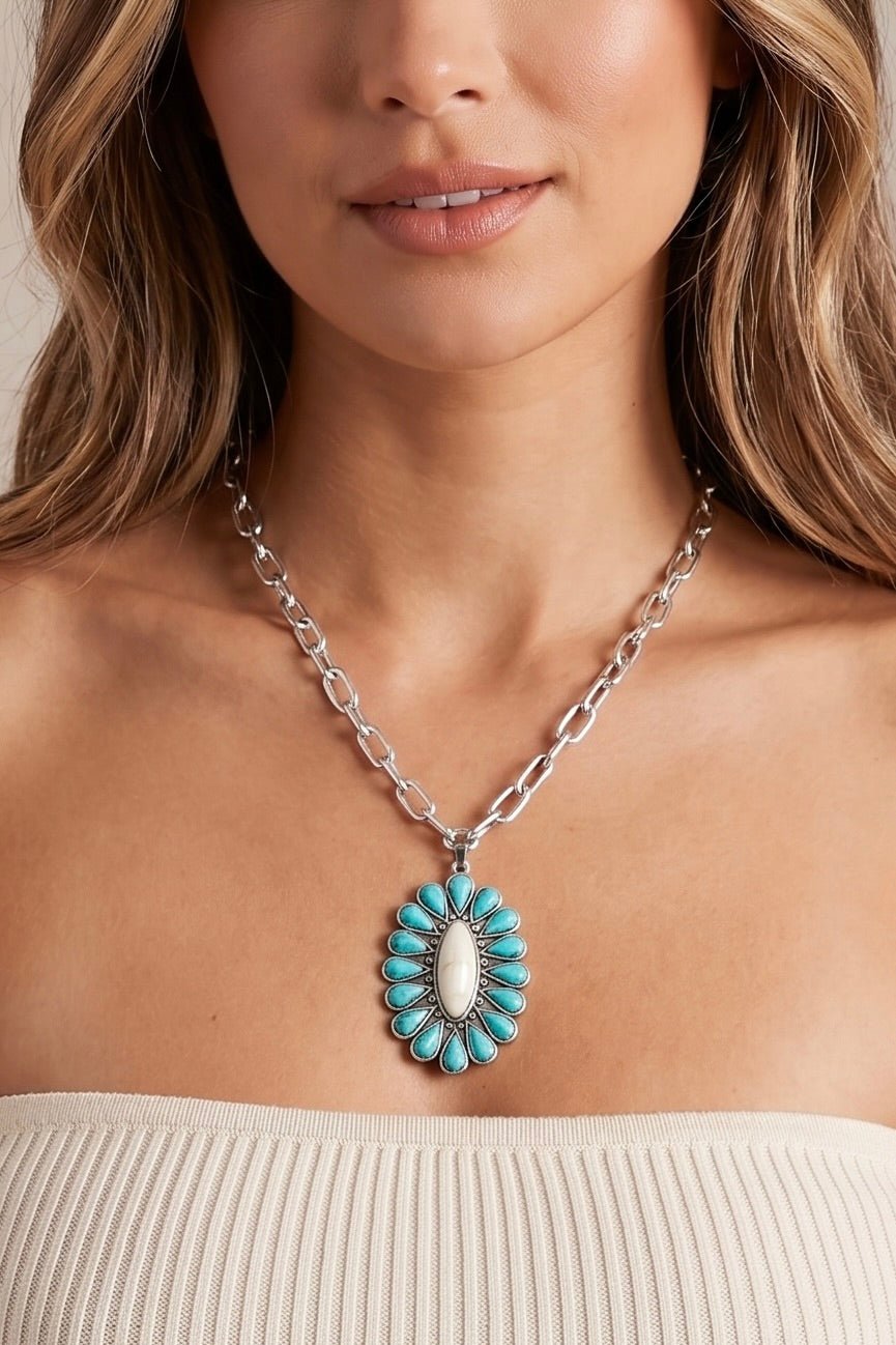 Western turquoise pendant necklace featuring a silver chain and a Southwestern-inspired turquoise and white stone concho pendant, perfect for rodeo outfits, country concerts, and boho cowgirl style.
