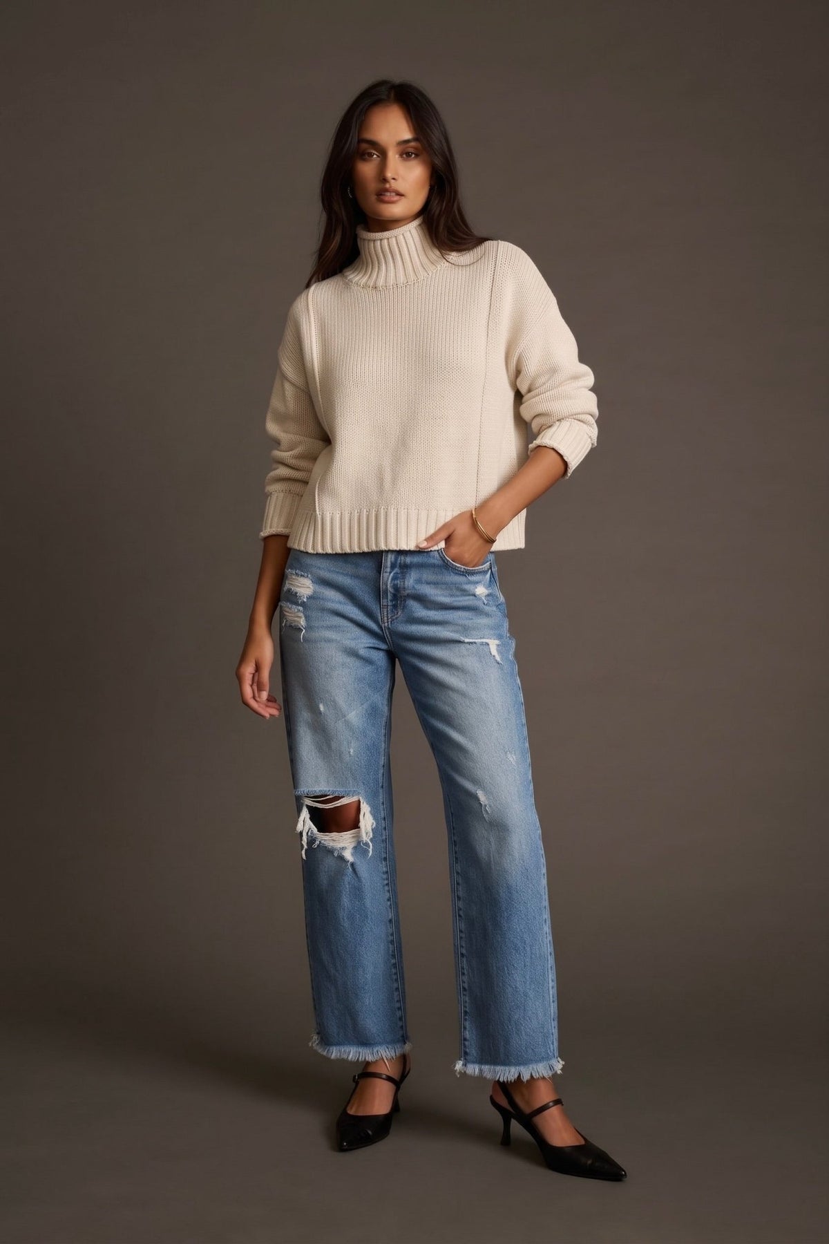 Women’s ivory cream knit turtleneck sweater featuring a chunky ribbed fold-over neckline, relaxed boxy silhouette, dropped shoulders, long sleeves and ribbed cuffs and hem. A classic neutral pullover sweater for cozy everyday outfits, fall and winter layering, casual styling and elevated cold-weather looks.