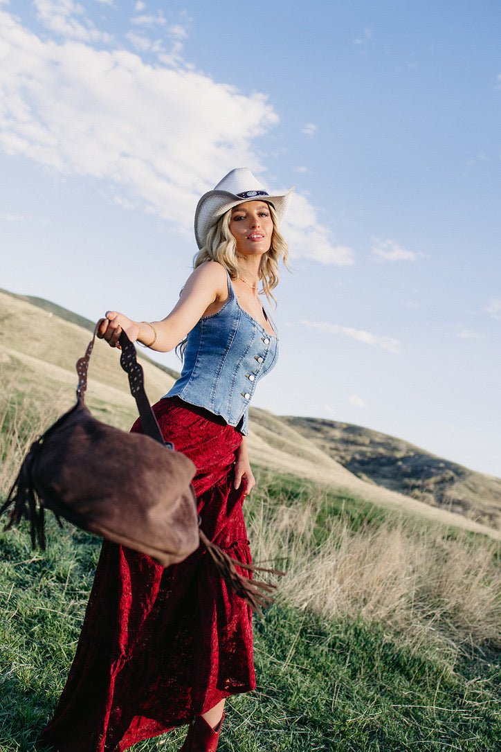 Western fringe crossbody bag with studded strap and buckle detailing