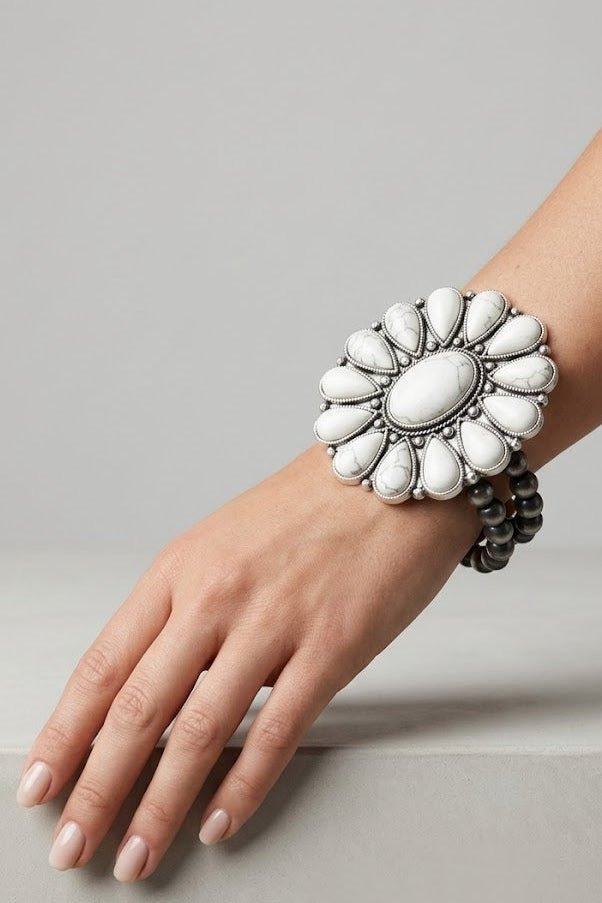 Oversized handmade white turquoise stretch bracelet featuring a floral-inspired Navajo design, antique silver finish, and double-strand Navajo pearl beads worn on the wrist.