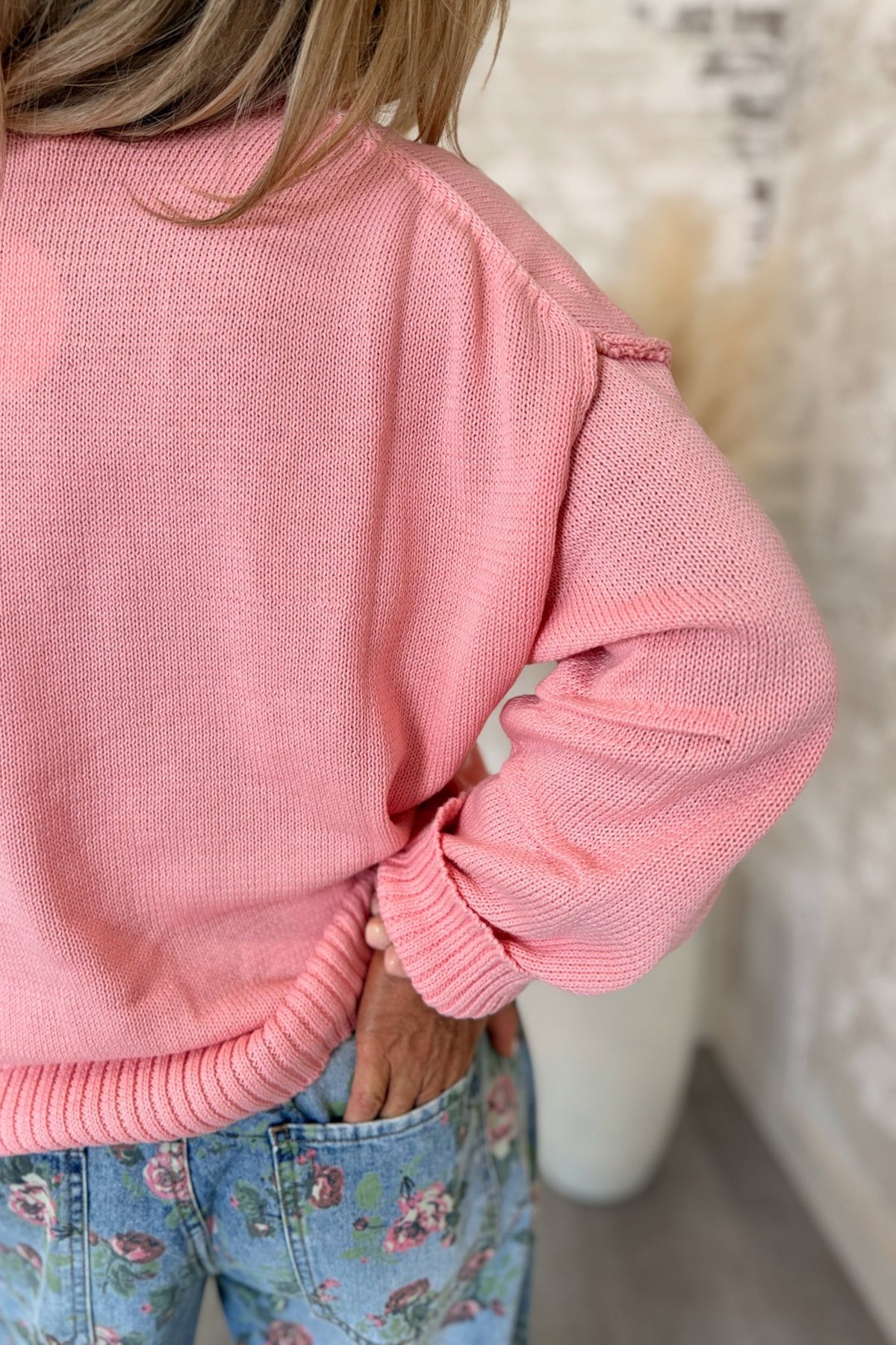 Women’s bubblegum pink knit sweater featuring a relaxed oversized fit, classic crew neckline, dropped shoulders, long sleeves, ribbed cuffs, and a wide ribbed hem with a slightly cropped silhouette for an easy everyday layering style.