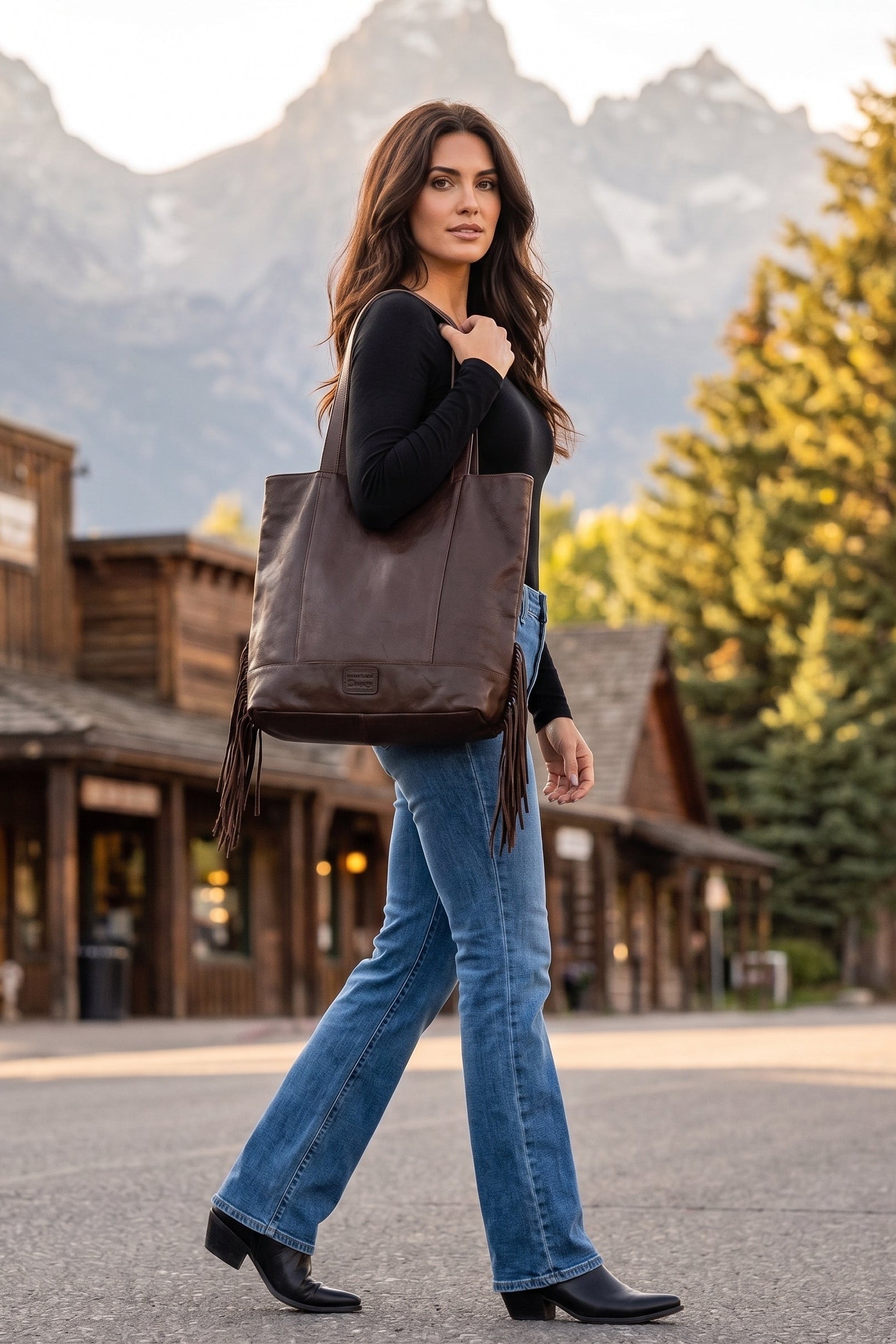 Rich Soil dark brown genuine leather Western tote bag with long shoulder straps, roomy silhouette and fringe detailing along the back.