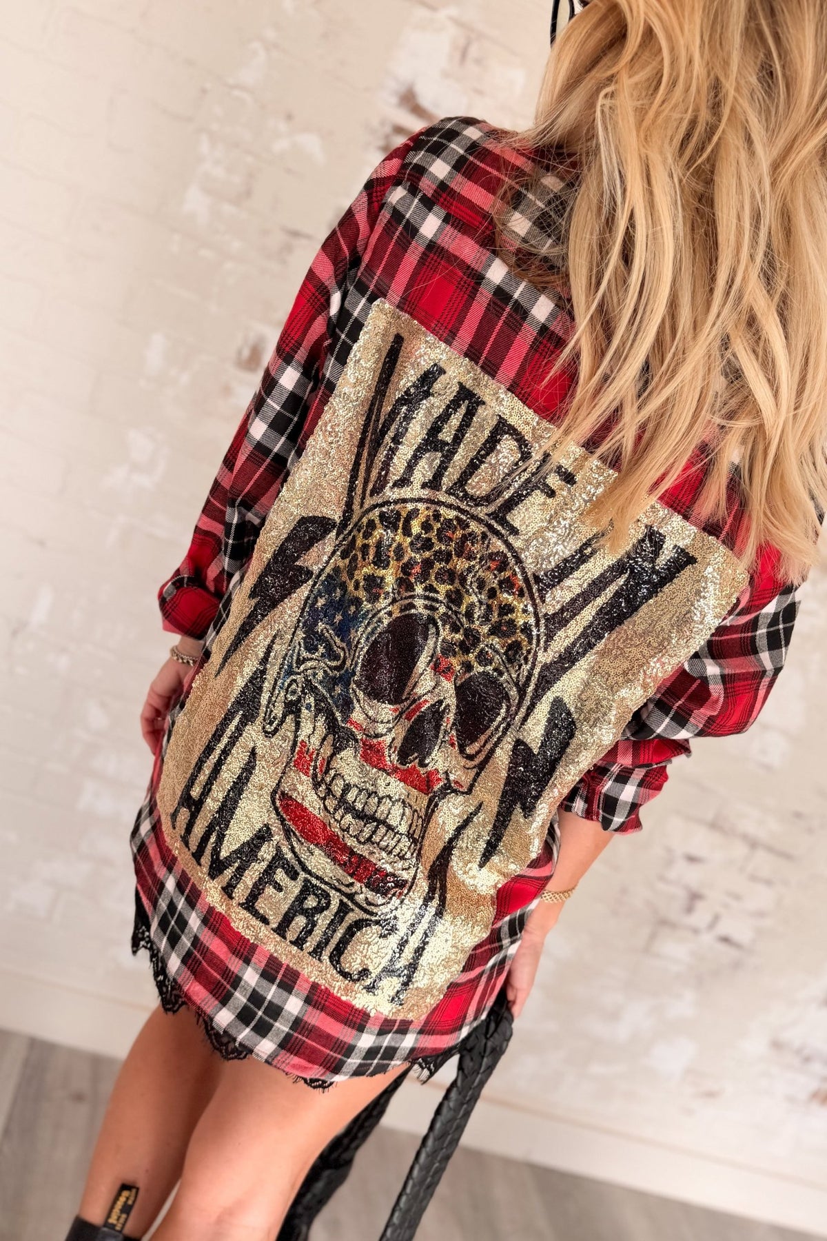 Women’s red, black and cream plaid flannel button-down shirt featuring a relaxed oversized fit, collared neckline, long sleeves, button front closure and dual chest flap pockets. Classic tartan plaid shirt styled as an easy layering piece for casual, grunge-inspired and fall outfits.