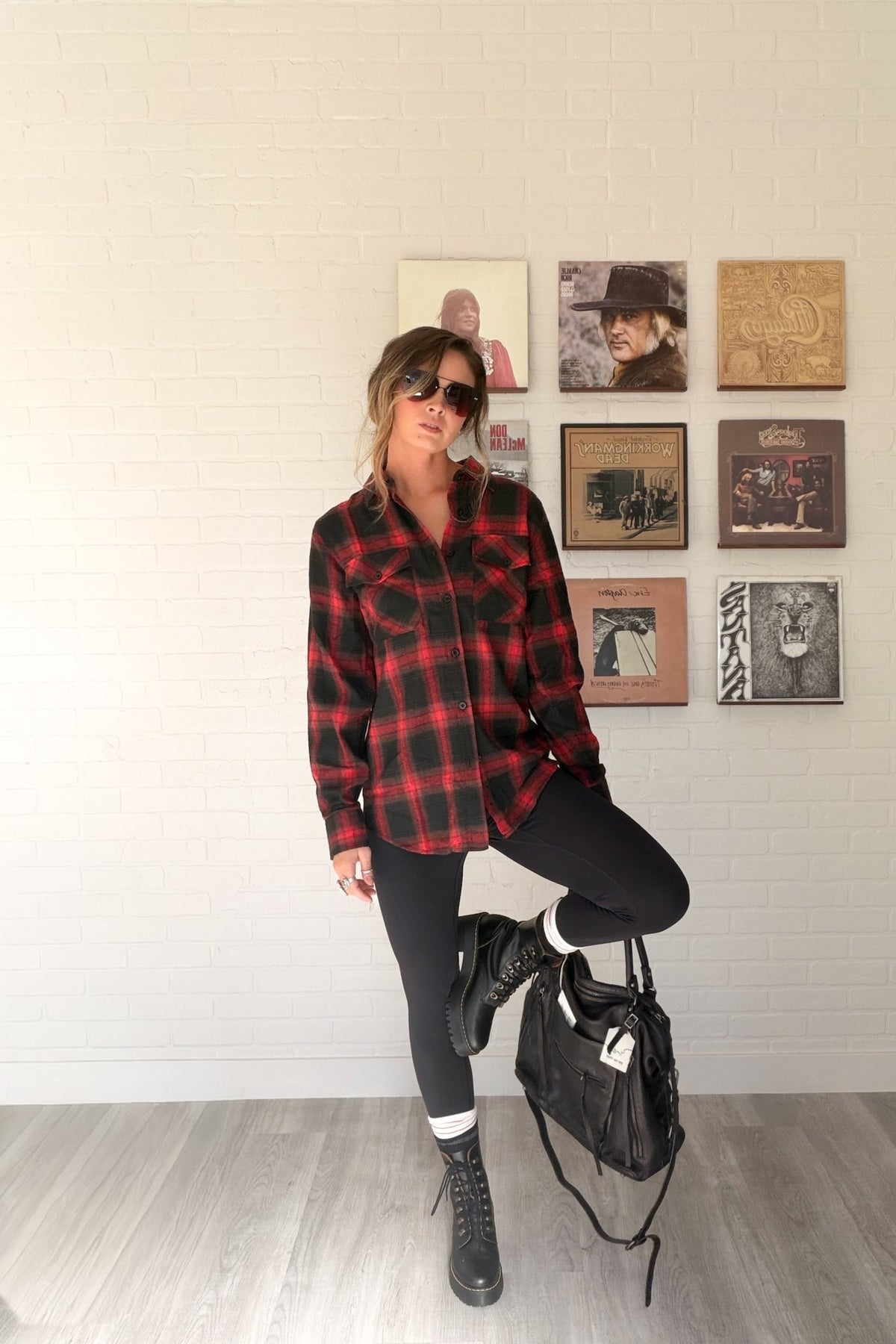 Women’s red, black and cream plaid flannel button-down shirt featuring a relaxed oversized fit, collared neckline, long sleeves, button front closure and dual chest flap pockets. Classic tartan plaid shirt styled as an easy layering piece for casual, grunge-inspired and fall outfits.