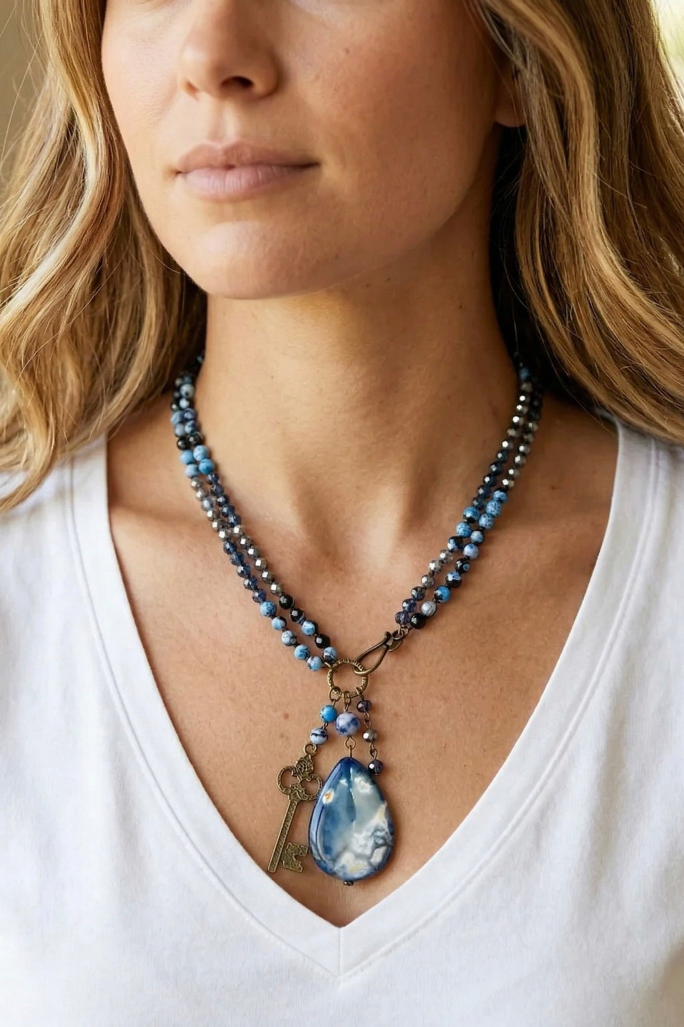 unquie blue beaded necklace with statement pendant and key