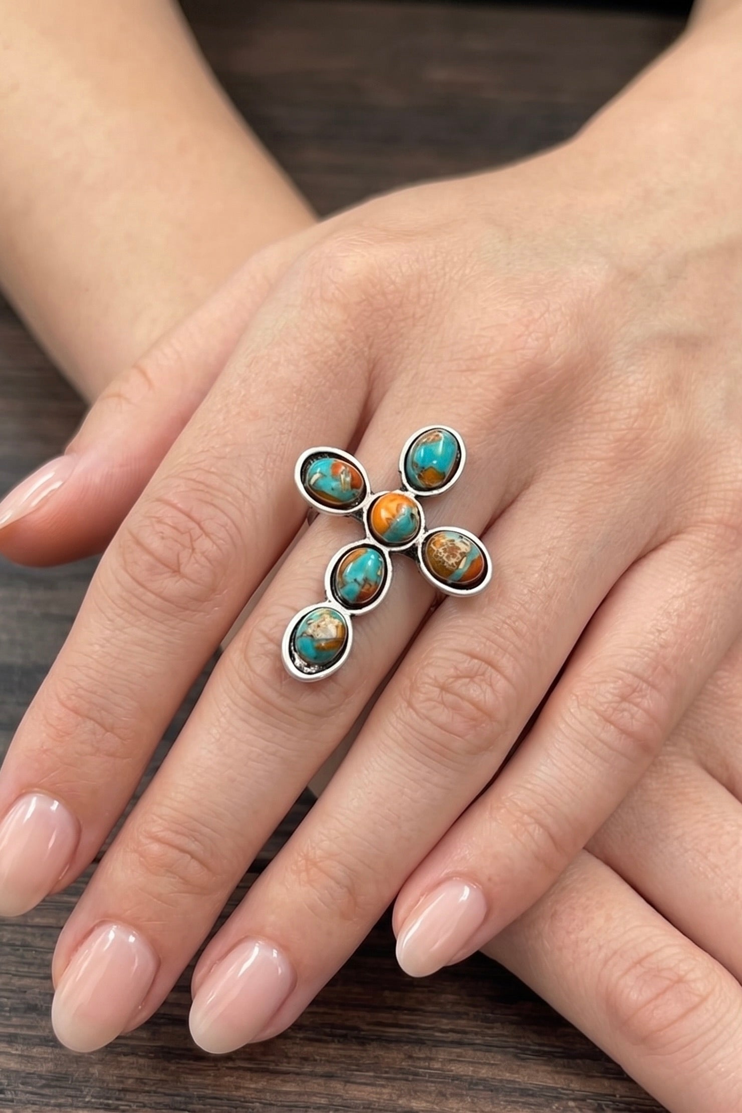 Natural gemstone cross statement ring with turquoise and earthy-toned stones, antique silver finish, and adjustable dual brass band.