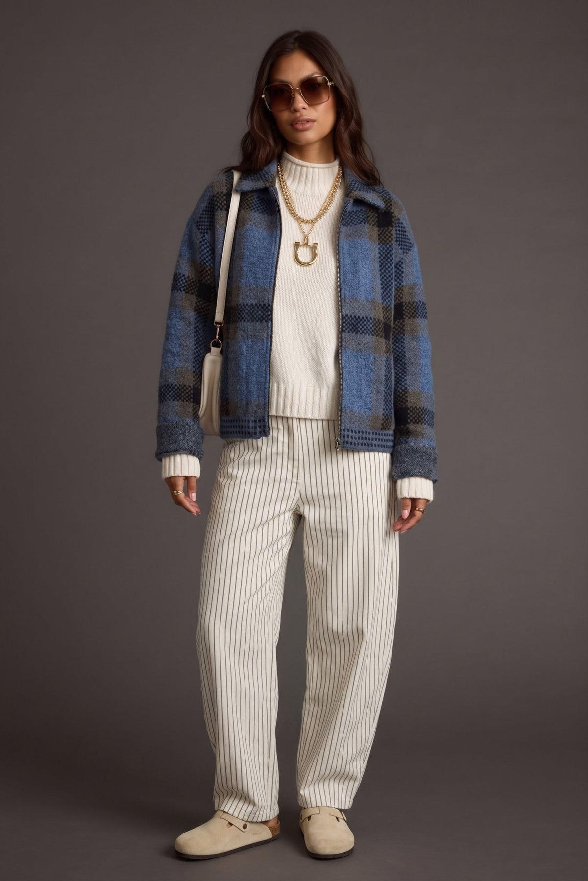 Women's dusty blue, charcoal gray, and brown plaid knit sweater jacket featuring a soft, textured brushed knit fabric, oversized buffalo check-inspired plaid pattern, relaxed boxy silhouette, classic fold-over collar, full front zipper closure, dropped shoulders, and long sleeves. This cozy, hip-length zip-up cardigan jacket features contrasting textured knit details along the hem and cuffs, combining vintage-inspired plaid styling with modern casual outerwear. Perfect for fall layering, winter outfits, coz