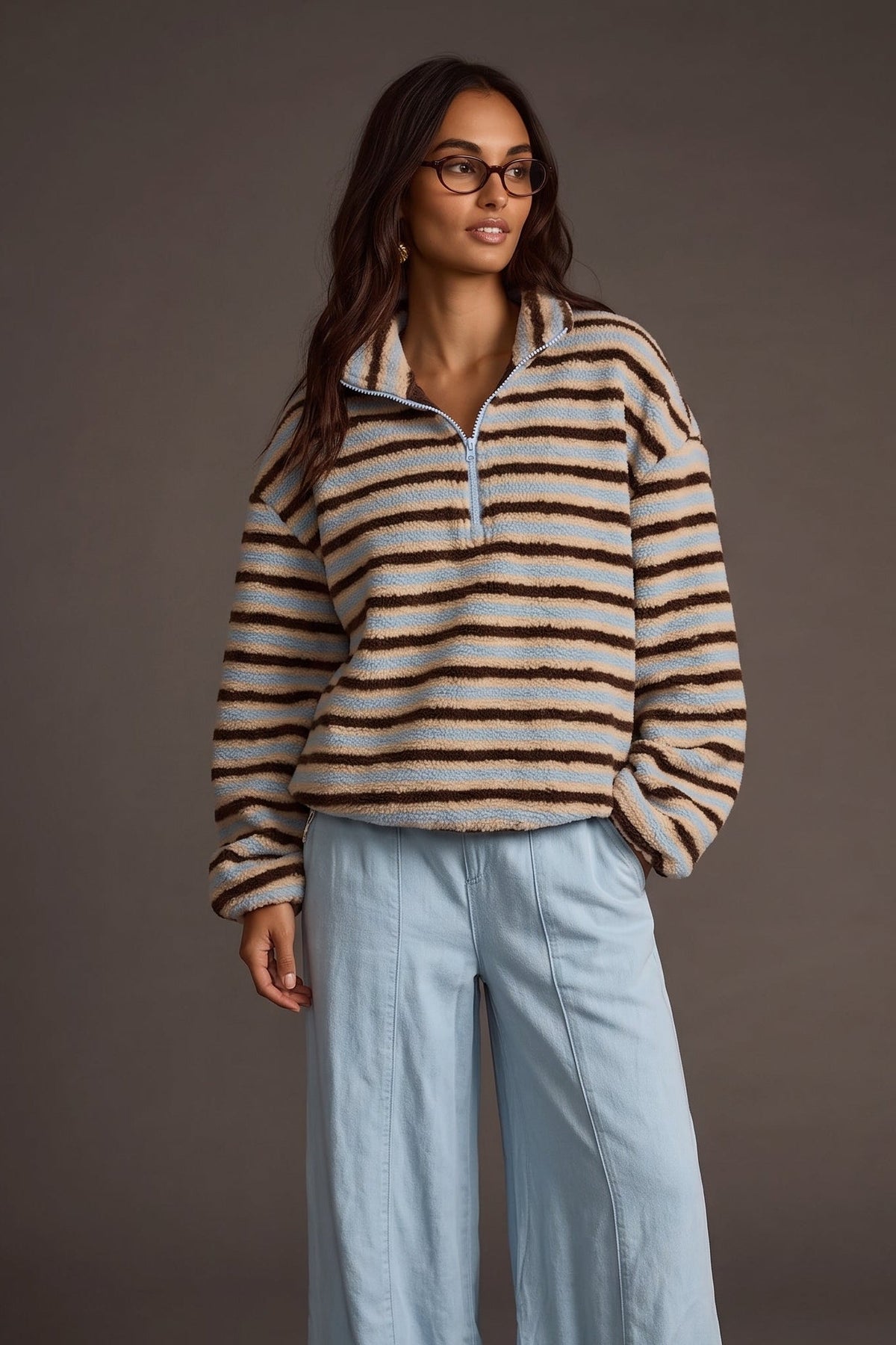 Fuzzy sherpa quarter zip jacket with blue, brown, and tan stripes. Elastic on the bottom of the sleeves