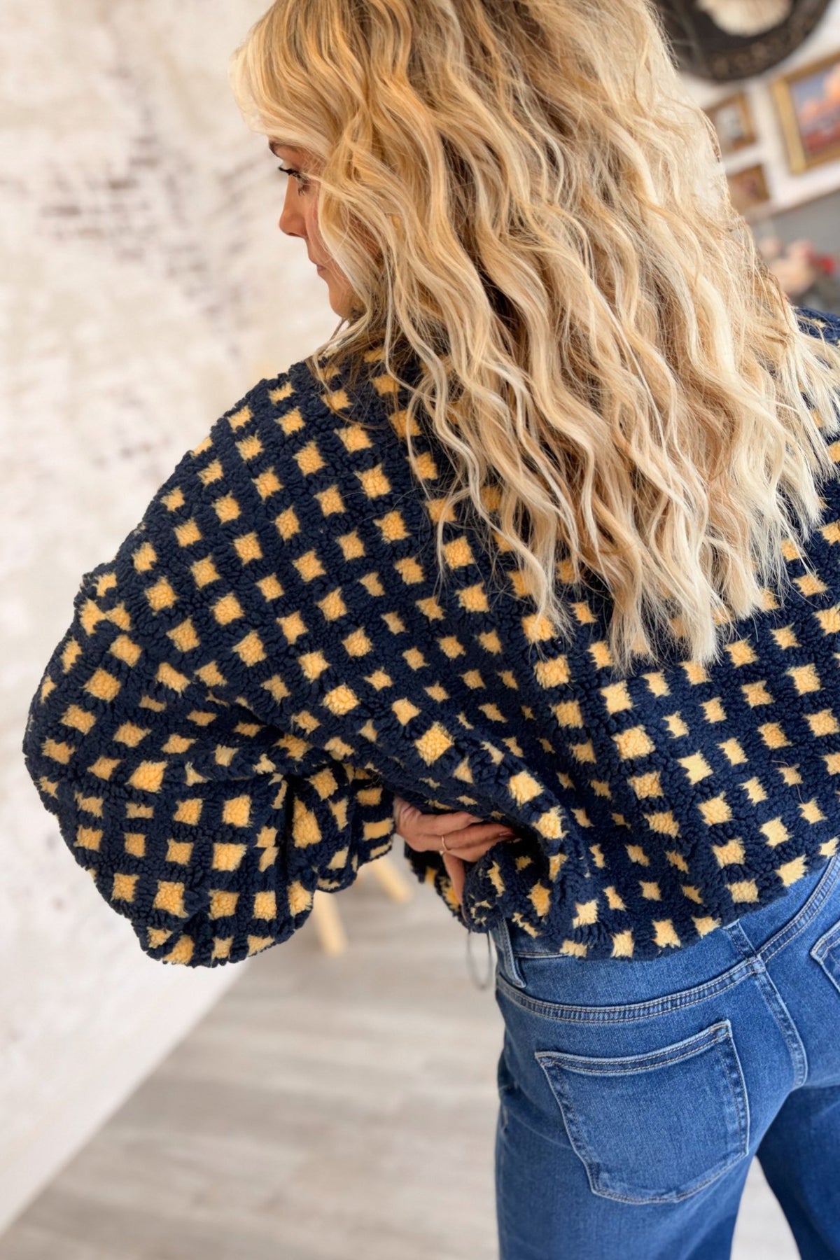 Women's navy blue and buttery yellow checkered sherpa fleece zip-up jacket featuring an allover gingham-inspired square pattern, plush textured teddy fabric, oversized relaxed silhouette, high stand collar, full front zipper closure, long voluminous sleeves with gathered elastic cuffs, and an adjustable drawstring hem for a customizable fit. This cozy, cropped-style sherpa jacket combines retro checkerboard styling with a playful, sporty aesthetic, perfect for casual fall outfits, winter layering, everyday 