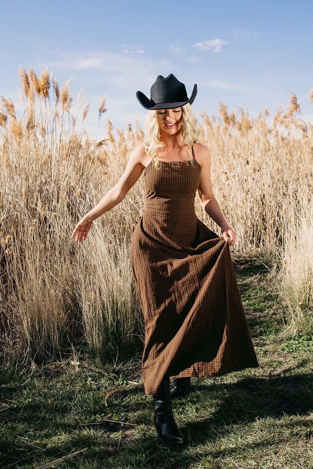 Brown western maxi dress styled for country concert outfits, boho western fashion, festival cowgirl looks and modern rodeo style from Sand + Charcoal Boutique.