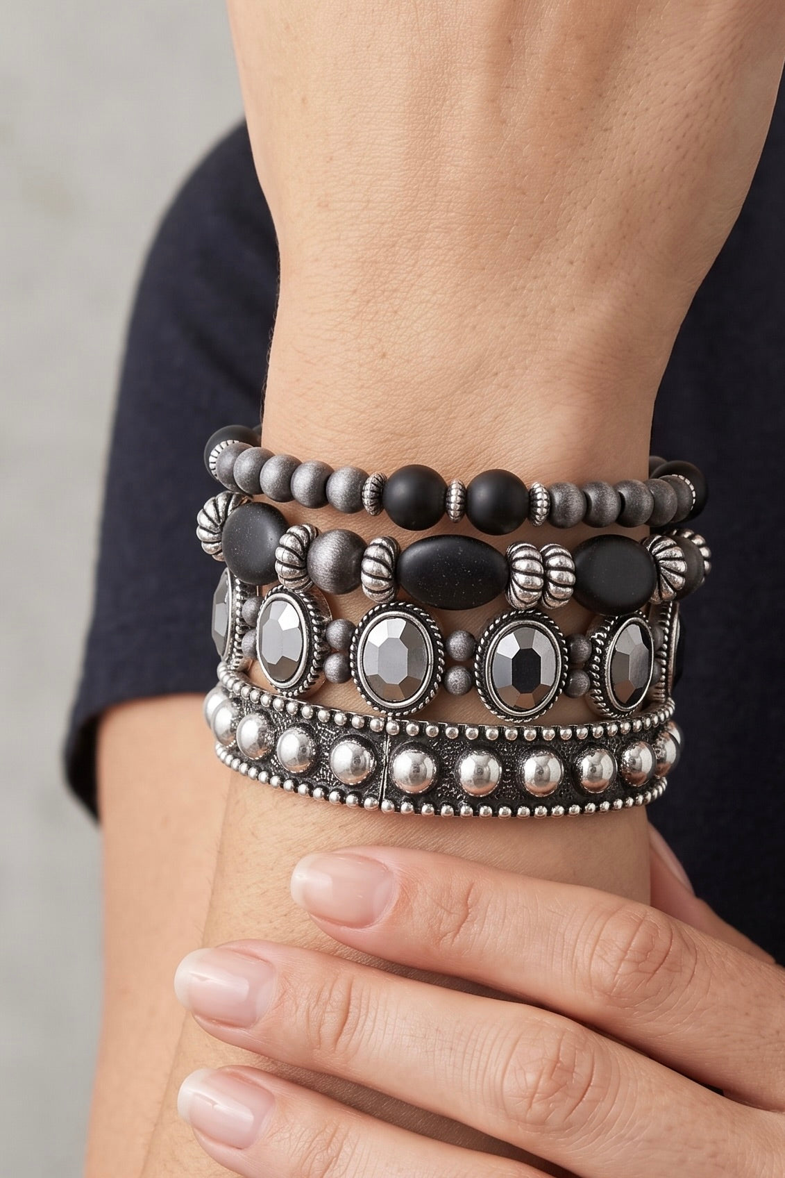 Layered black beaded stretch bracelet set featuring silver-tone accents, faceted crystal details, and stacked Western-inspired statement bracelets.