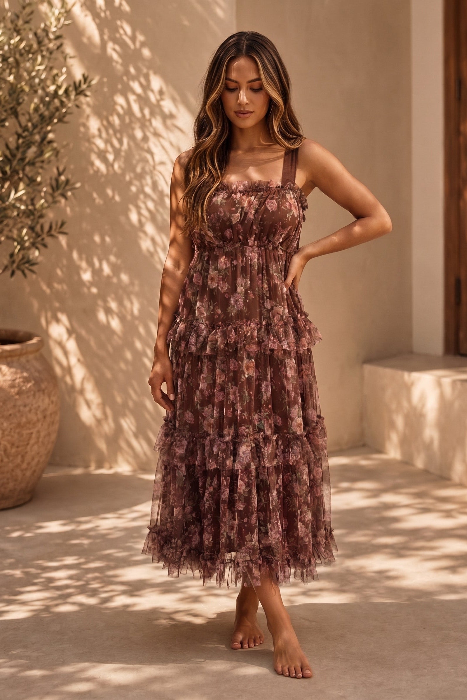Brown floral chiffon midi dress with square neckline, wide straps, elastic waist, tiered skirt, and feminine ruffle trim detailing.
