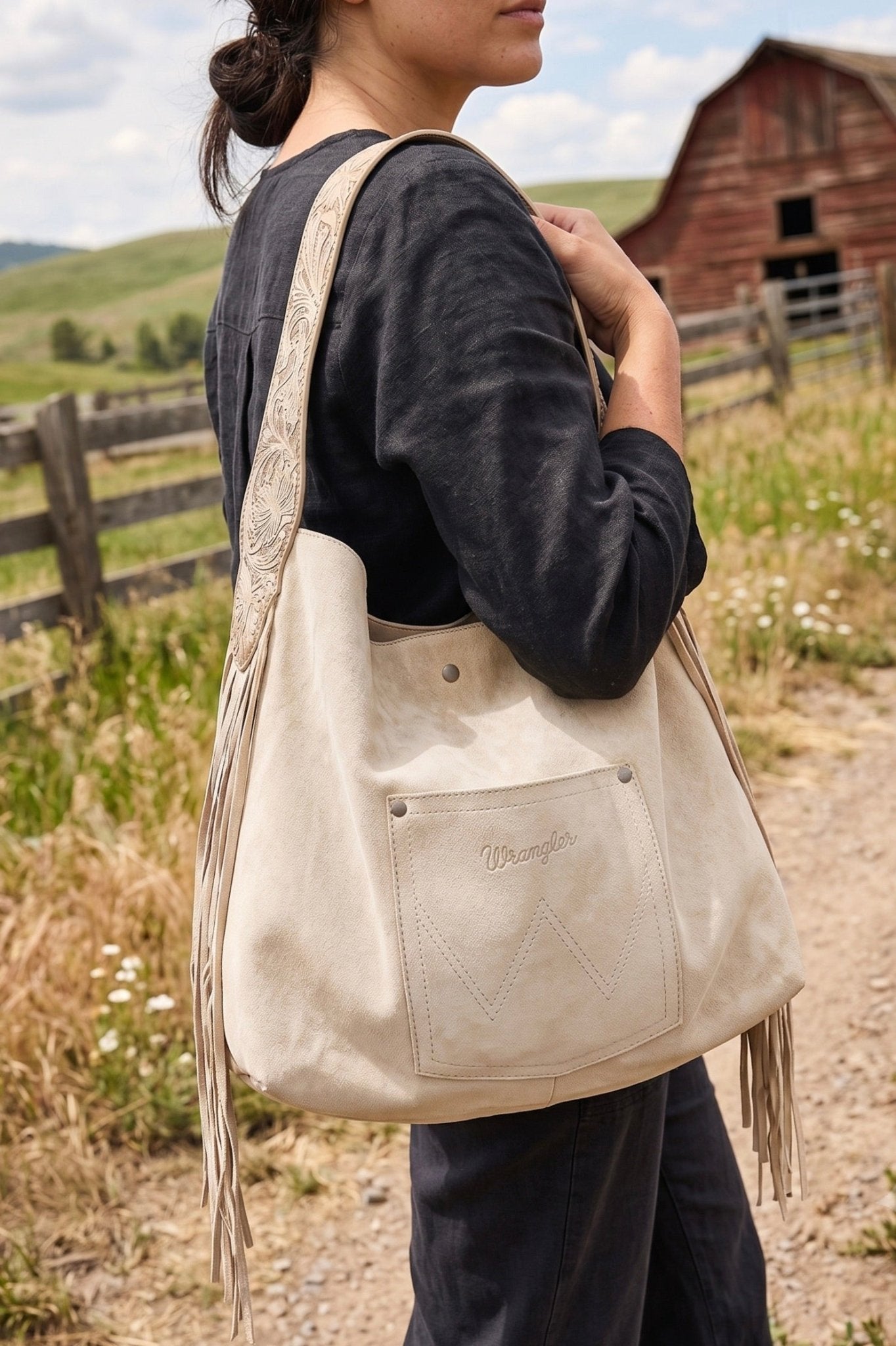 Soft suede like tote bag. Stamped handle design, front pocket with side fringe 